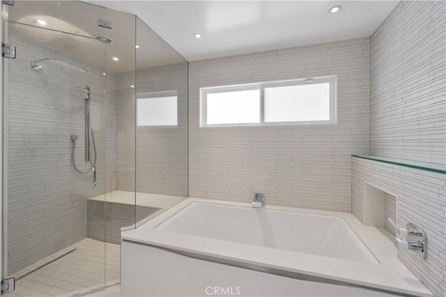 bathroom with shower with separate bathtub