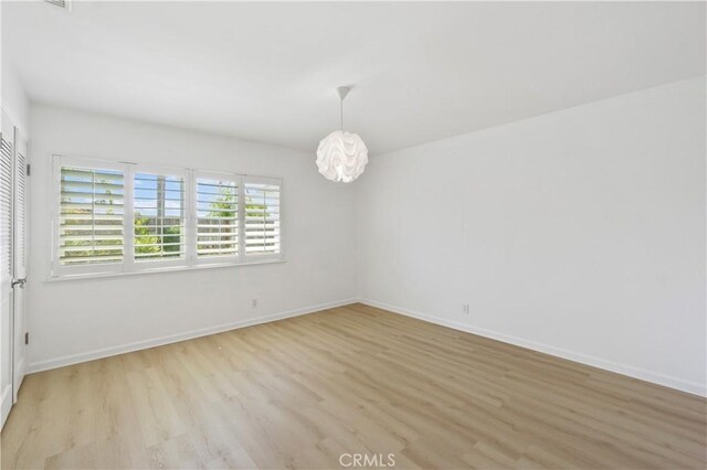 spare room with light hardwood / wood-style floors