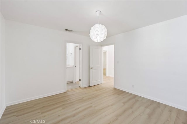 empty room with light hardwood / wood-style flooring