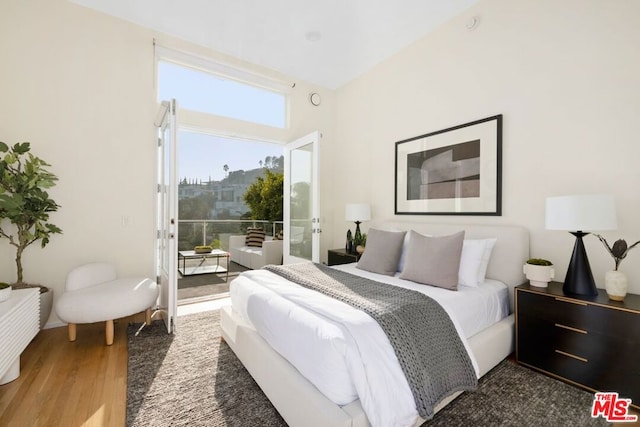 bedroom featuring access to outside and hardwood / wood-style floors