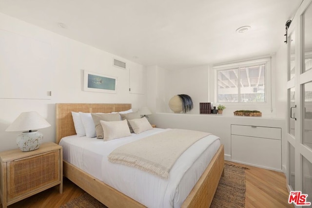 bedroom with wood-type flooring