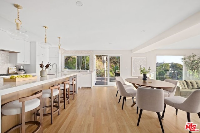 dining room featuring light wood-type flooring and sink