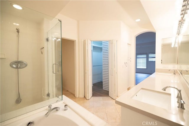 bathroom with separate shower and tub, vanity, and tile patterned flooring