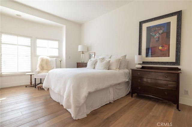 bedroom with wood-type flooring