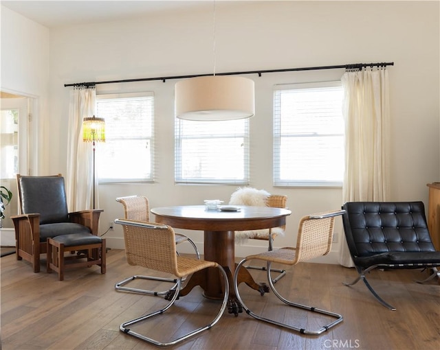 dining area with hardwood / wood-style flooring and plenty of natural light