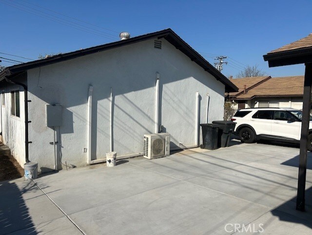 view of side of home featuring ac unit and a patio