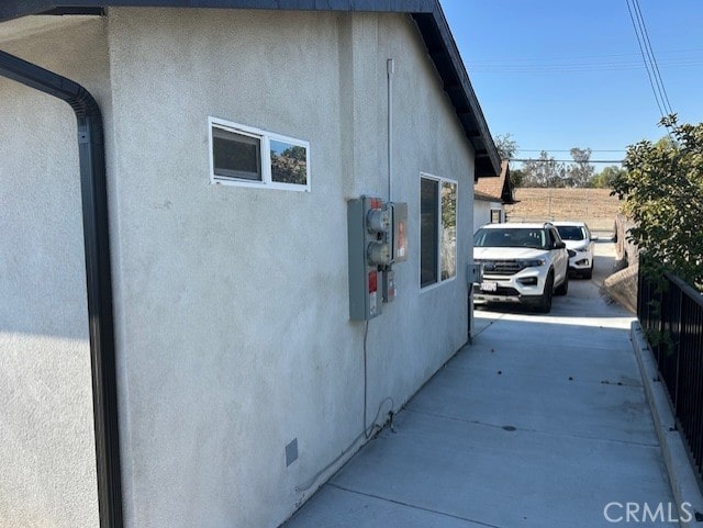 view of property exterior with crawl space and stucco siding