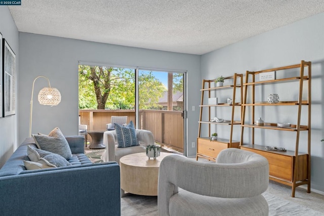 carpeted living room featuring a textured ceiling