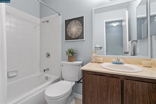 full bathroom with vanity, tiled shower / bath combo, and toilet