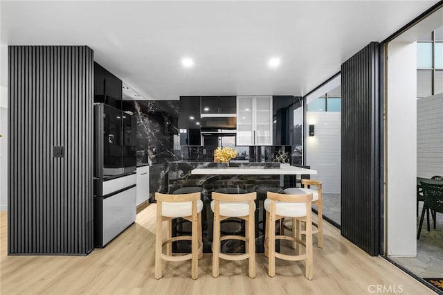 kitchen featuring white cabinets, light wood-style floors, and smart refrigerator