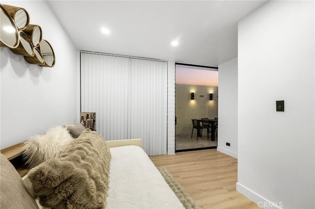 bedroom with light wood finished floors, recessed lighting, and baseboards