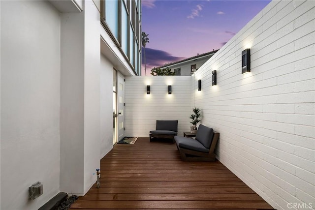 deck at dusk with an outdoor living space