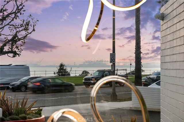 exterior space featuring traffic signs and a water view