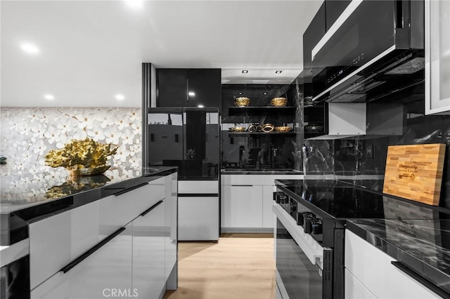 kitchen featuring range with electric stovetop, modern cabinets, and white cabinets