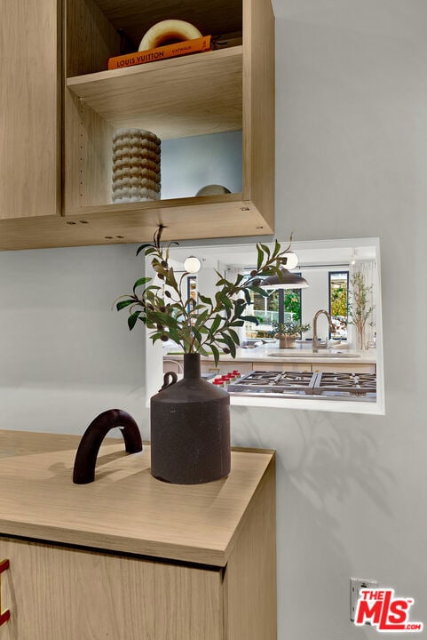 interior details featuring sink and stainless steel gas stovetop