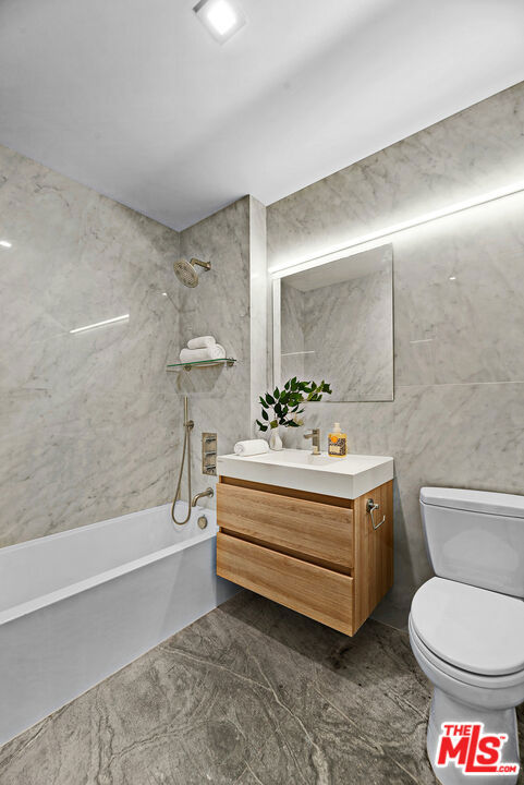 full bathroom featuring shower / bathtub combination, toilet, and vanity