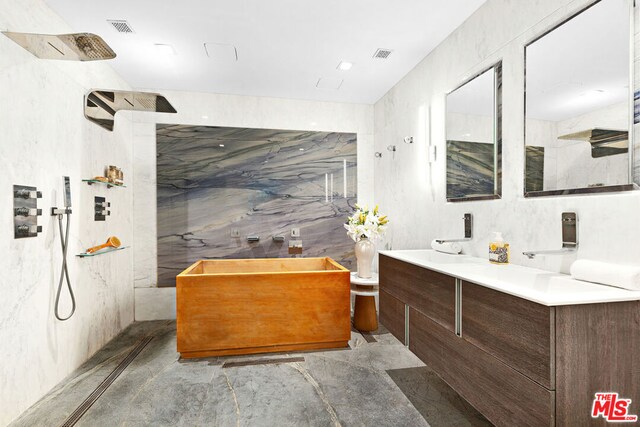 bathroom with tile walls, vanity, and separate shower and tub