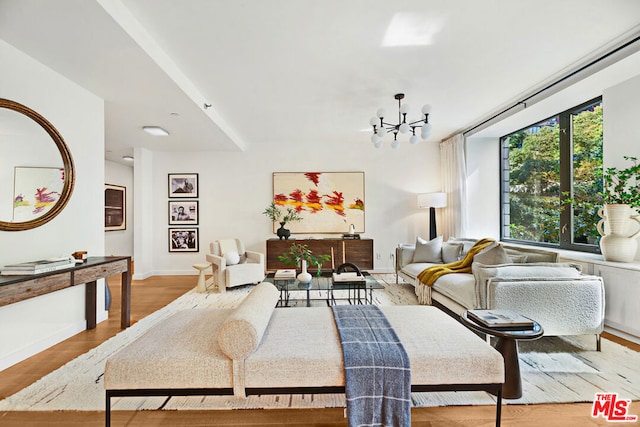 living room featuring an inviting chandelier and light hardwood / wood-style floors