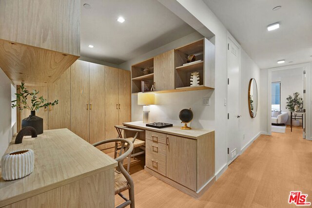 office area with built in desk, built in features, and light hardwood / wood-style flooring