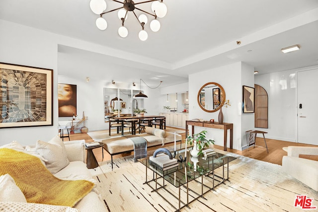 living room featuring a chandelier and light hardwood / wood-style floors