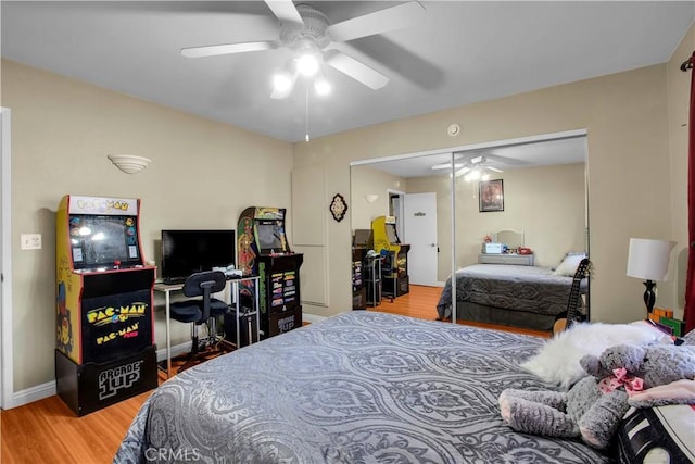 bedroom with ceiling fan, a closet, and hardwood / wood-style floors