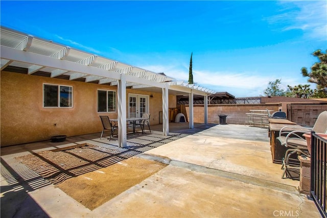 view of patio / terrace featuring french doors and a pergola