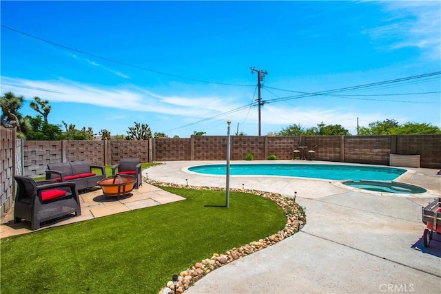 view of pool with an in ground hot tub, an outdoor fire pit, a yard, and a patio