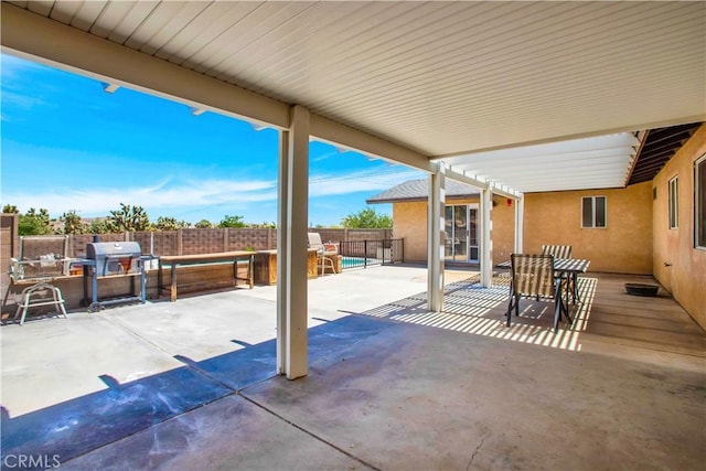 view of patio / terrace with a pool and area for grilling