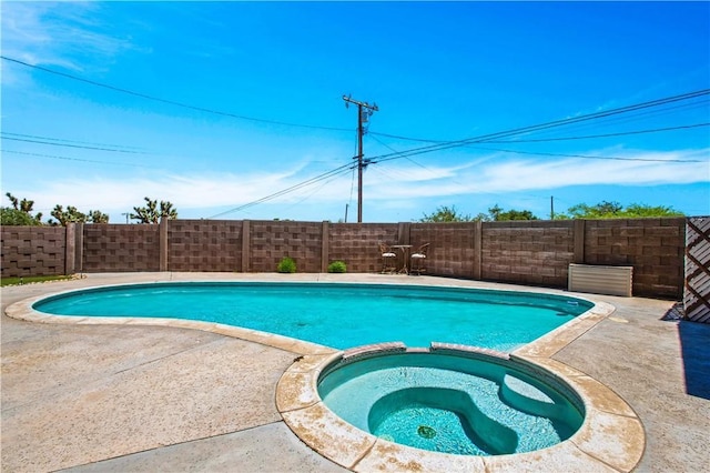 view of pool with an in ground hot tub