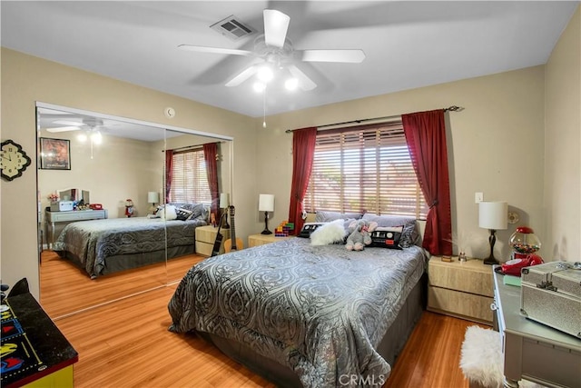 bedroom with ceiling fan, a closet, and hardwood / wood-style floors