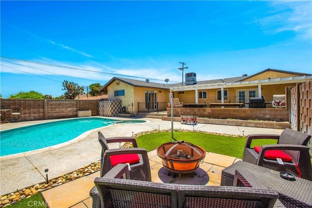 view of pool featuring a patio area and a fire pit