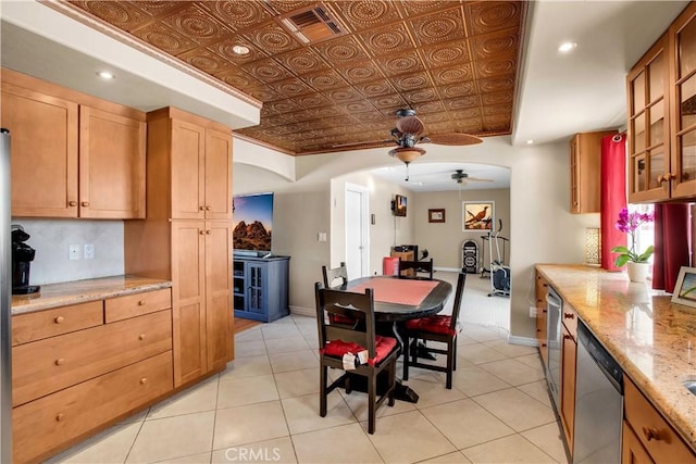 kitchen featuring stainless steel dishwasher, ceiling fan, light stone countertops, and light tile patterned flooring