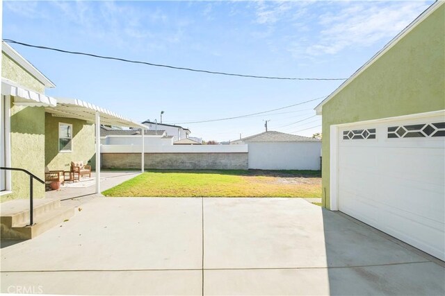 view of patio with a garage and an outdoor structure