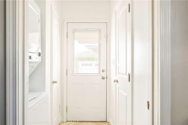 entryway featuring stacked washer / drying machine