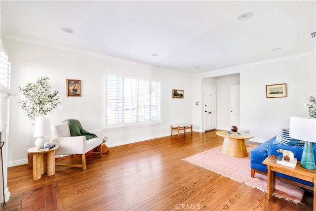 sitting room featuring crown molding and hardwood / wood-style floors