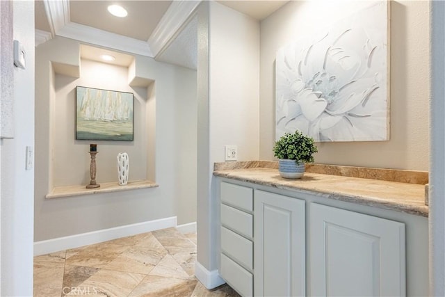 bathroom featuring vanity and ornamental molding