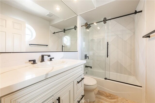 full bathroom featuring toilet, enclosed tub / shower combo, and vanity