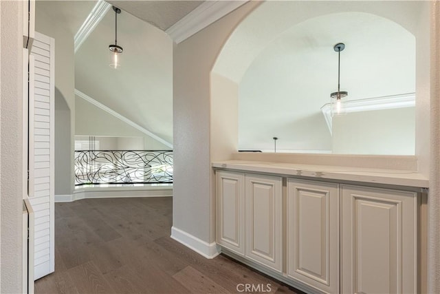 hallway with vaulted ceiling, dark wood-type flooring, and crown molding