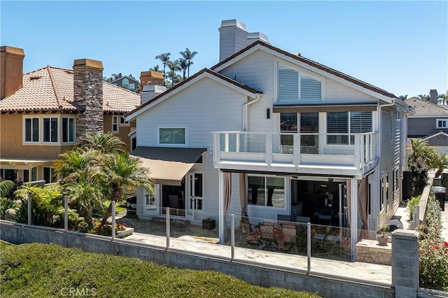 back of property with a balcony