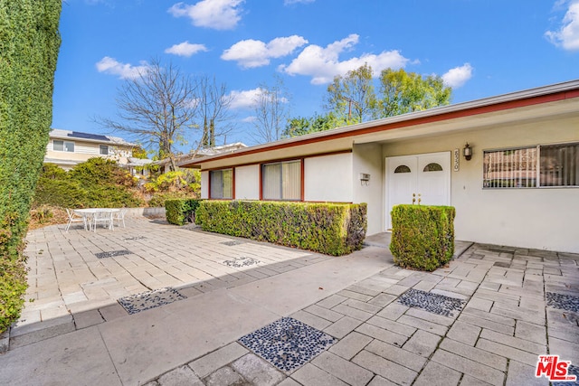 entrance to property with a patio