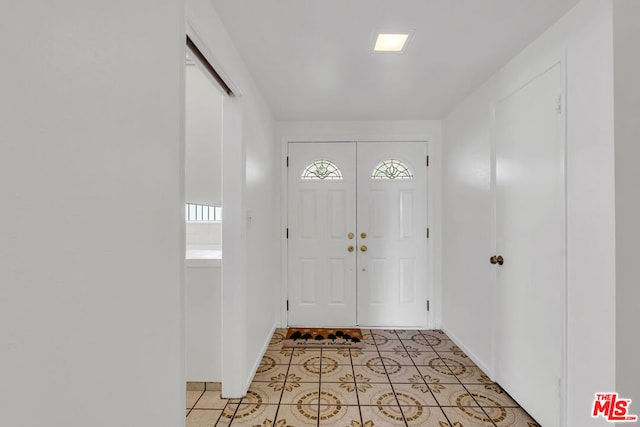 entryway with light tile patterned flooring