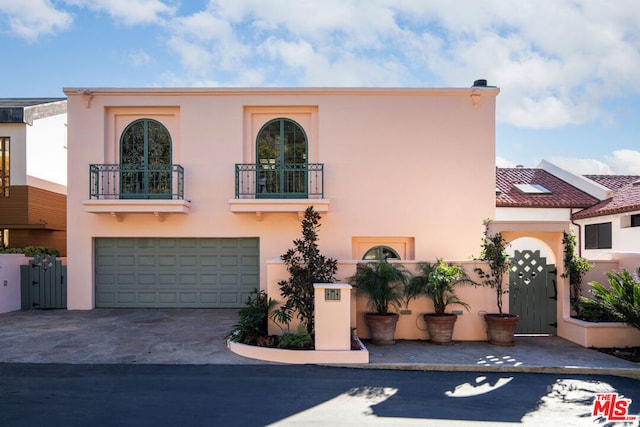 view of front of property with a garage and a balcony