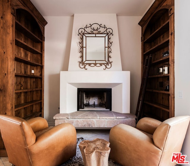 living area featuring tile patterned flooring and a fireplace