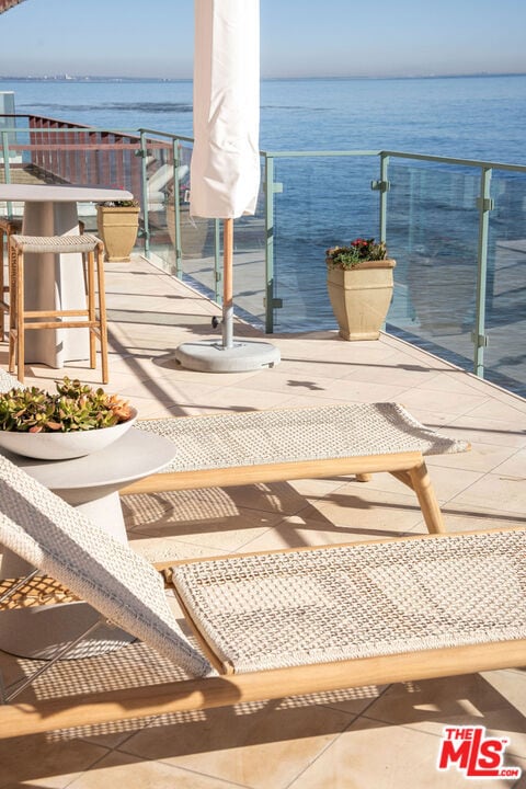 balcony featuring a water view