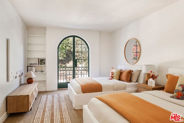 bedroom featuring carpet and access to exterior