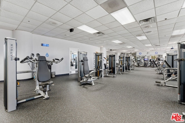 gym with a paneled ceiling