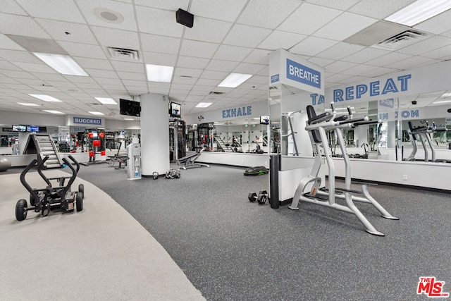 exercise room with a paneled ceiling