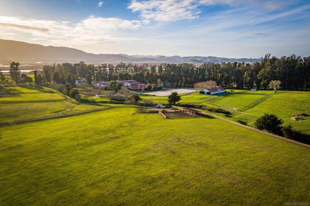 exterior space featuring a rural view, a yard, and a mountain view