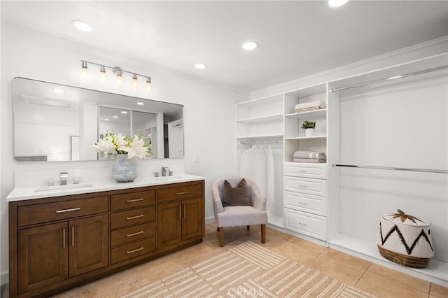 bathroom with crown molding, tile patterned floors, and vanity