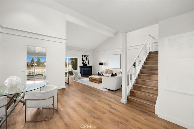 living room with lofted ceiling with beams and wood-type flooring